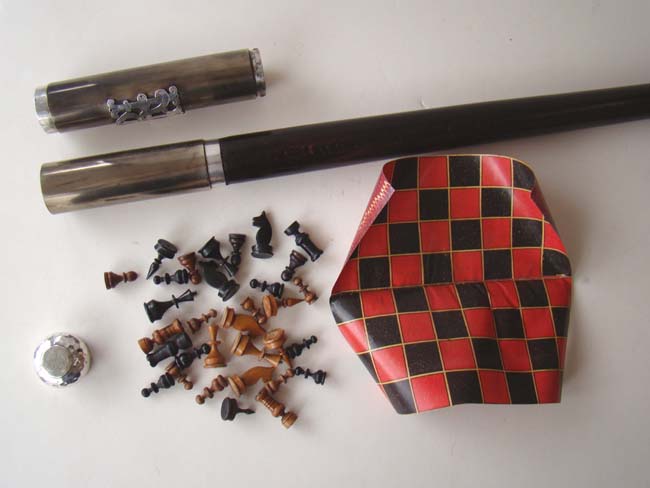 A FABULOUS Silver mounted Walking Stick containing a complete carved wooden chess set and fold up chess board circa 1900.
